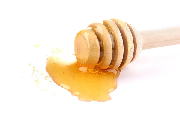 Søt honning på drizzler isolert på hvitt – stockfoto