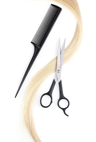 Shiny blond hair with hair cutting shears and comb isolated on white Stock Photo