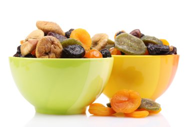 Dried fruits in bright bowls isolated on white