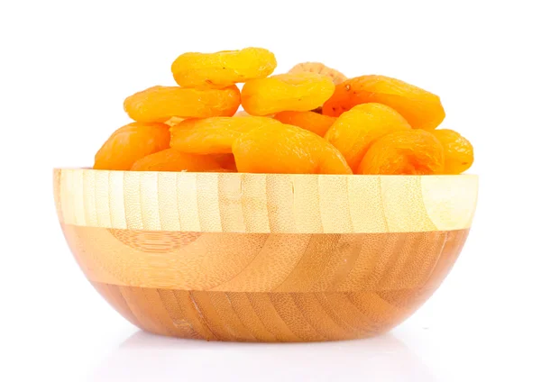 Delicious dried apricots in wooden bowl isolated on white — Stock Photo, Image