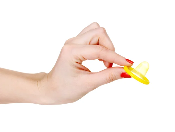 Hand som håller en kondom isolerad på vit — Stockfoto