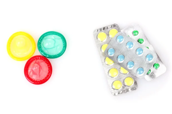 Geburtskondome und Antibabypillen isoliert auf weiß — Stockfoto