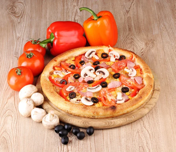 Aromatic pizza with vegetables and mushrooms on wooden background — Stock Photo, Image