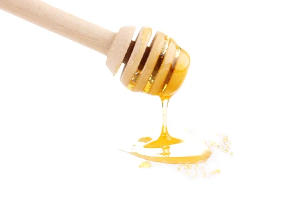 Søt honning på drizzler isolert på hvitt – stockfoto
