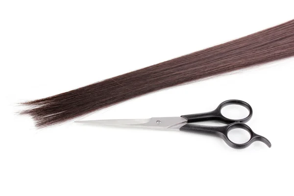 Shiny brown hair and hair cutting shears isolated on white — Stock Photo, Image