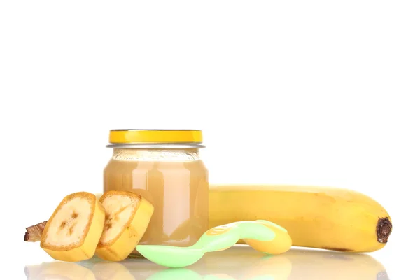 Jar of baby puree with banana and spoon isolated on white — Stock Photo, Image