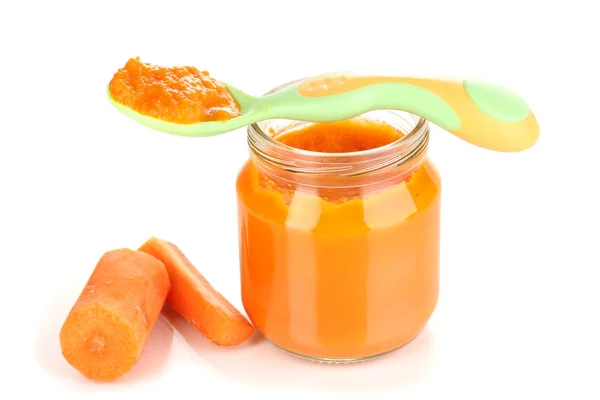 Jar of baby puree with carrot and spoon isolated on white — Stock Photo, Image