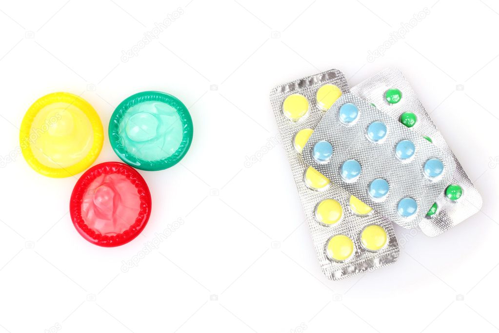 Birth condoms and control pills isolated on white