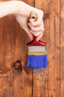 Painting wooden fence with yellow paint clipart