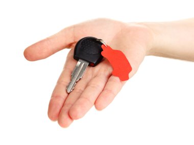 Car key with charm in hand isolated on white clipart