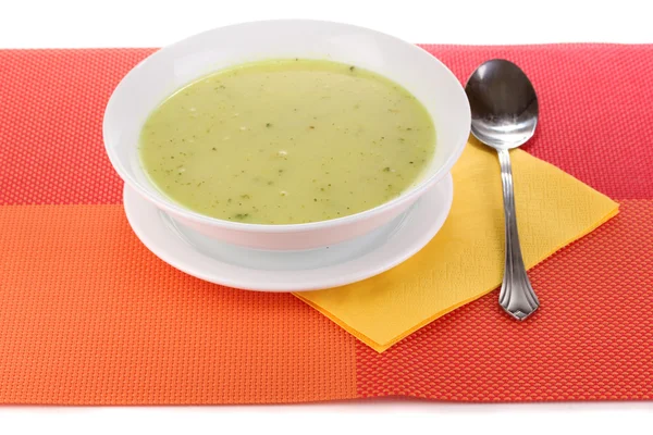 Tasty soup on red tablecloth isolated on white — Stock Photo, Image