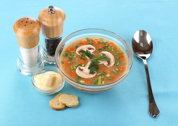 Tasty soup on blue tablecloth — Stock Photo, Image