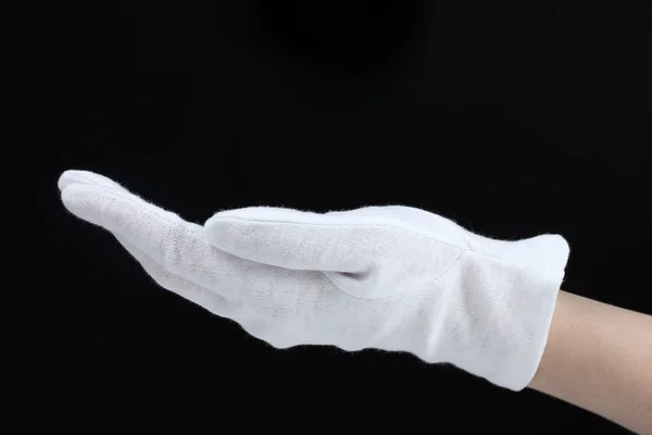 Tyg handske på handen på svart bakgrund — Stockfoto