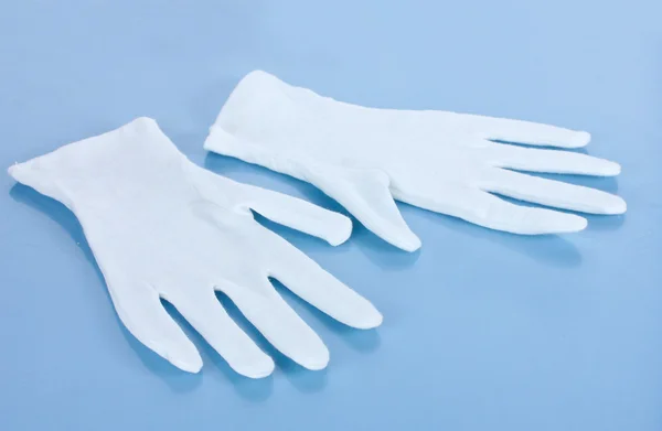 Тканинні рукавички на синьому фоні — стокове фото