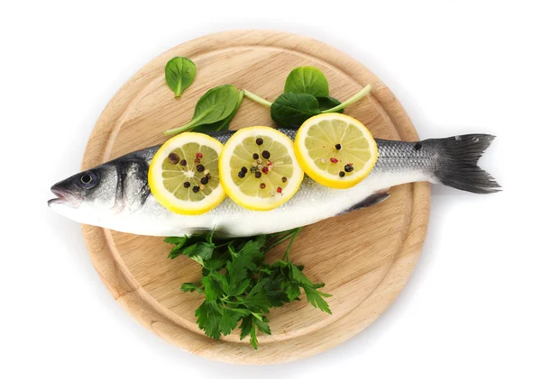 Fresh fish with lemon, parsley and pepper on wooden cutting board isolated on white — Stock Photo, Image
