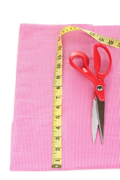 Scissors and measuring tape on fabric isolated on white — Stock Photo, Image