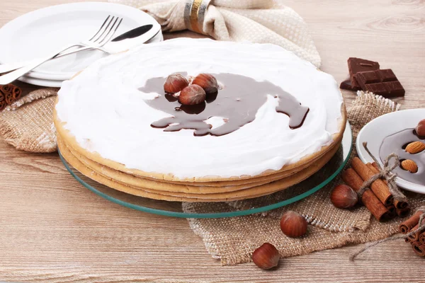 stock image Cake on glass stand and nuts on wooden table