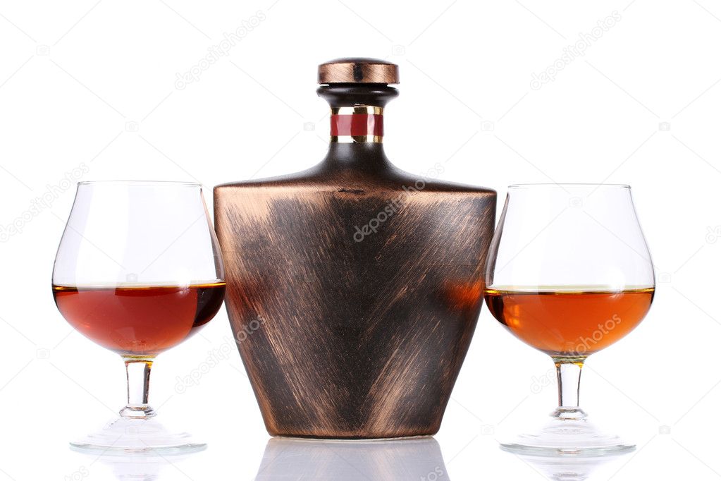 Glasses of brandy and bottle isolated on white