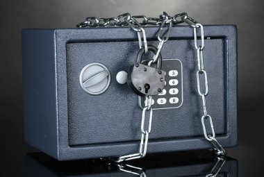 Safe with chain and lock on grey background clipart