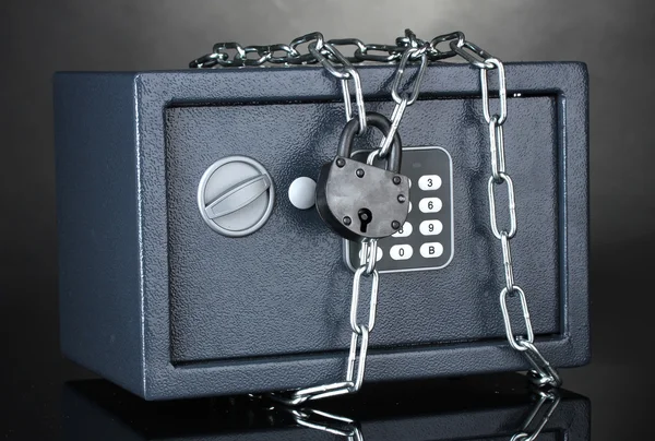 Safe with chain and lock on grey background — Stock Photo, Image