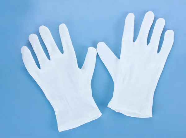 Látkové rukavice na modrém pozadí — Stock fotografie