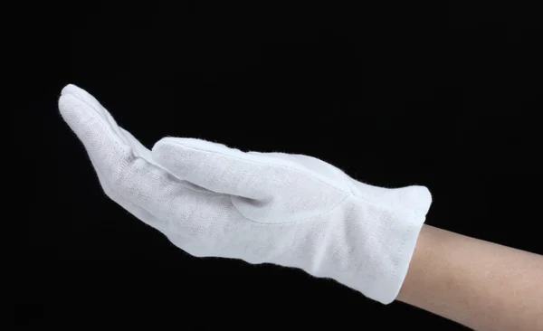 Тканинна рукавичка на руці на чорному тлі — стокове фото
