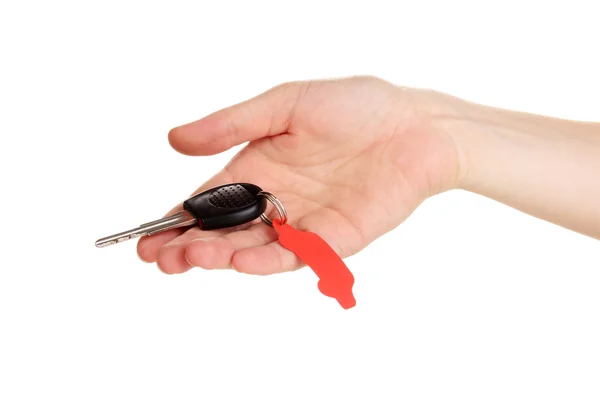 Car key with charm in hand isolated on white — Stock Photo, Image