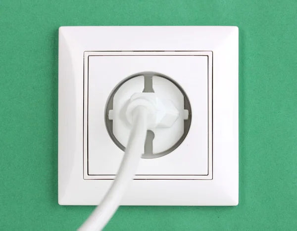 stock image White electric socket with plug on the wall