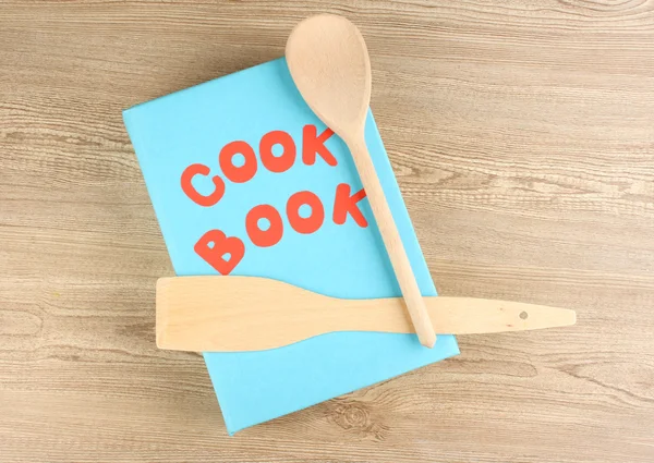 Cookbook and kitchenware on wooden background — Stock Photo, Image