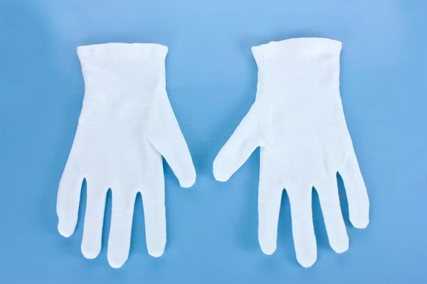 Cloth gloves on blue background — Stock Photo, Image