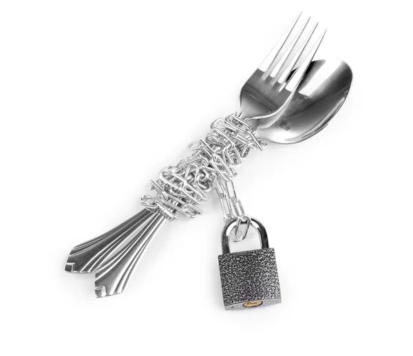 stock image Fork and spoon with chain and padlock isolated on white