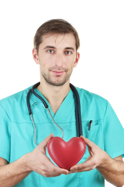 Mladý lékař muž s stetoskop a srdcem na modré pozadí — Stock fotografie