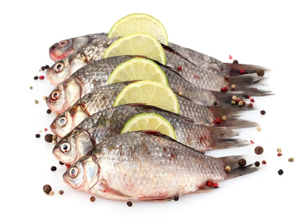 Свежие рыбы с лаймом и специями, изолированные на белом — стоковое фото