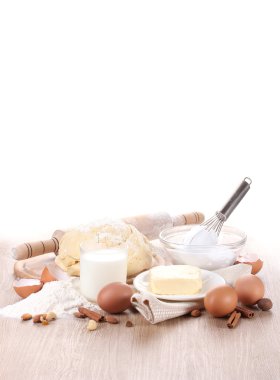 Ingredients for the dough wooden table on white background clipart