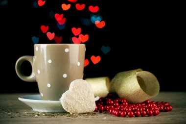 Cup of coffee on wooden table on bright bokeh backdground clipart