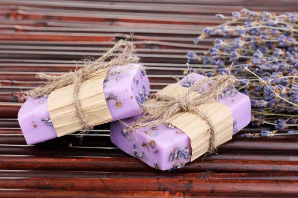 Hand-made lavender soaps on bamboo mat — Stock Photo, Image