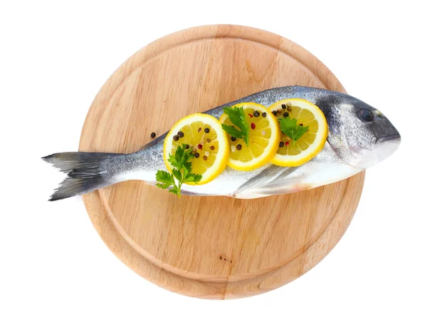 Verse vis met citroen, peterselie en peper op houten snijplank geïsoleerd op wit — Stockfoto