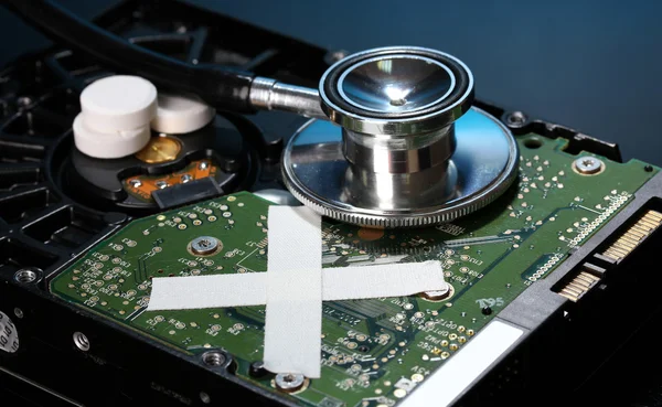 Hard disk drive on repairs on dark blue background — Stock Photo, Image