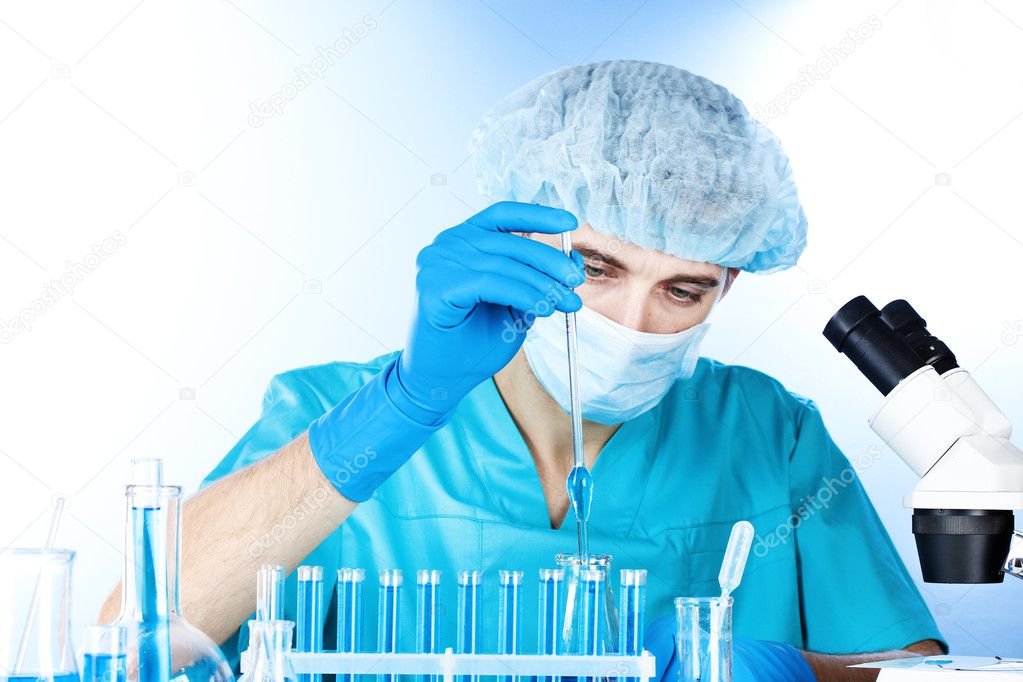 Scientist working with chemical test-tubes in lab
