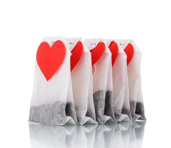 stock image Tea bags with blank heart-shaped labels isolated on white