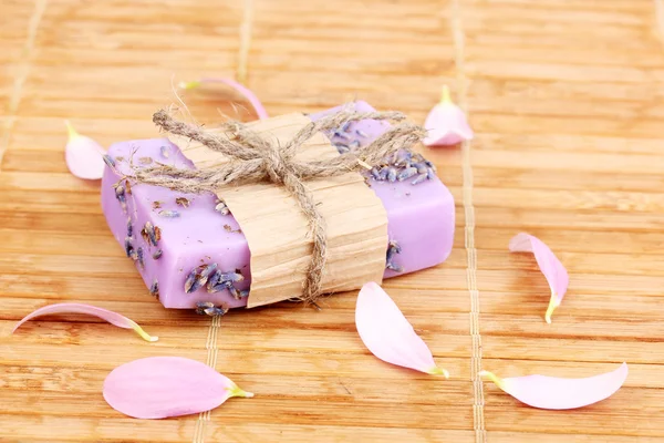 Hand-made lavender soap on wooden mat — Stock Photo, Image