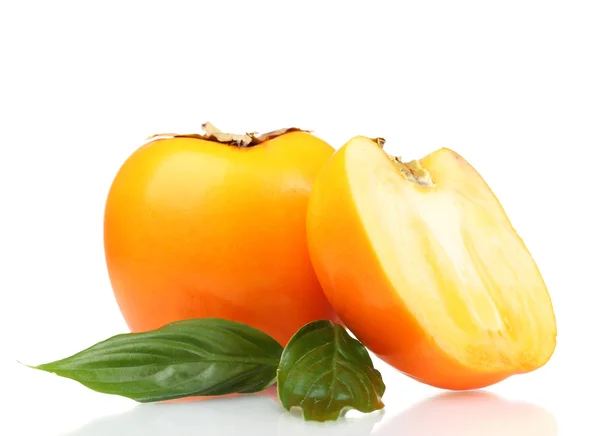 One and half appetizing persimmon with green leaves isolated on white — Stock Photo, Image