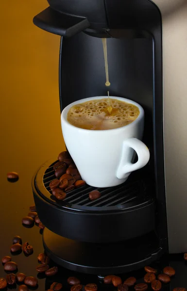 stock image Espresso machine pouring coffee in cup on brown background