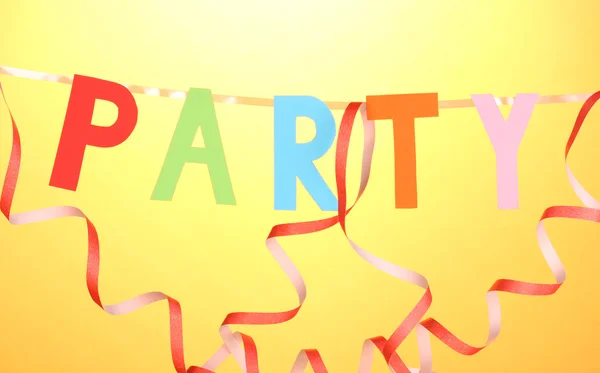 Party items close-up on orange background — Stock Photo, Image