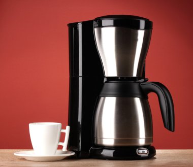 Coffee maker on red background clipart