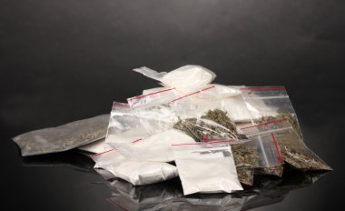 Cocaine and marihuana in packages on grey background clipart