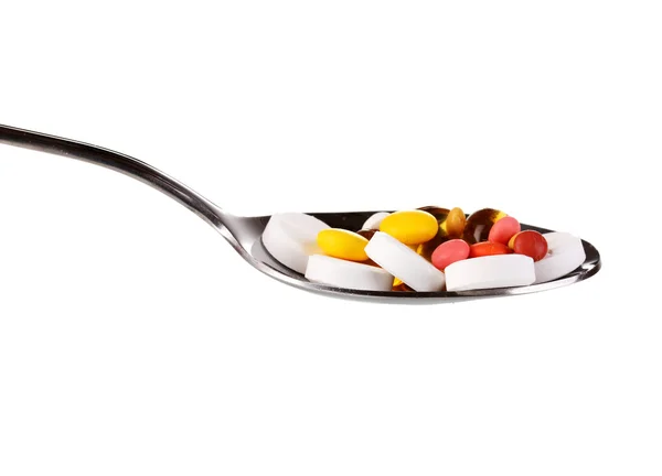 stock image Spoon with pills isolated on white