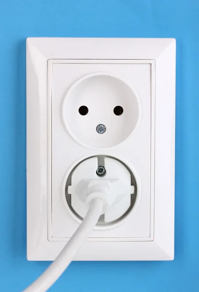 stock image White electric socket with plug on the wall