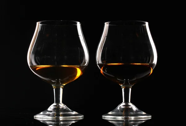 Kaksi lasillista konjakkia mustalla taustalla — kuvapankkivalokuva