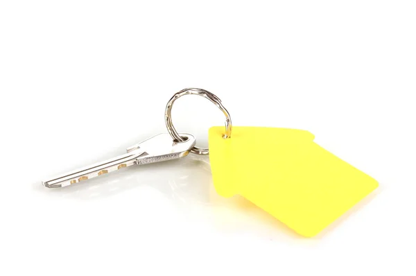 Nyckel med hus-formade charm isolerad på vit — Stockfoto